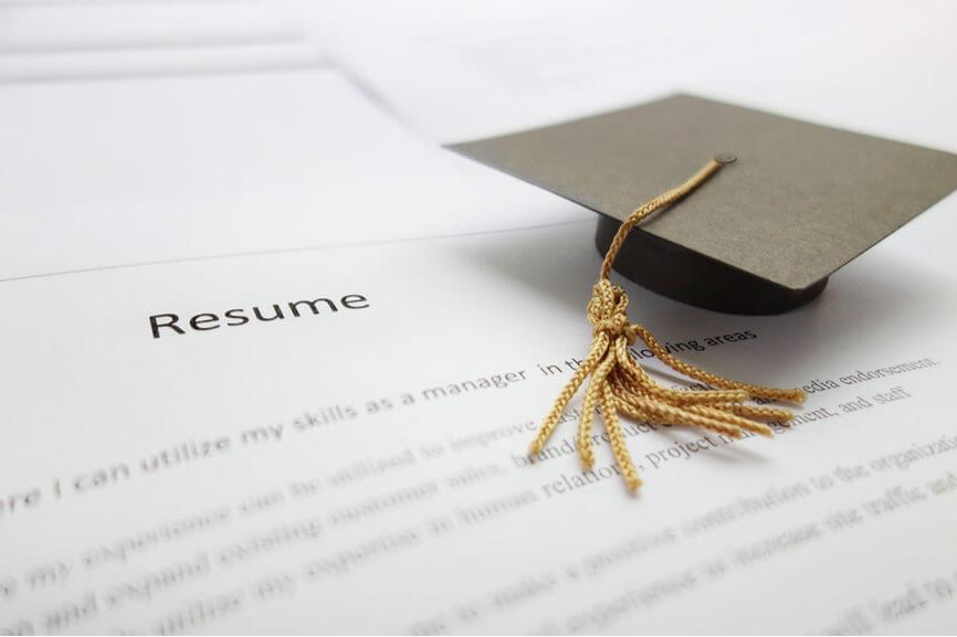 graduate cap sits on top of resume