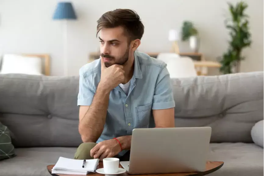 Young Man Thinking Laptop