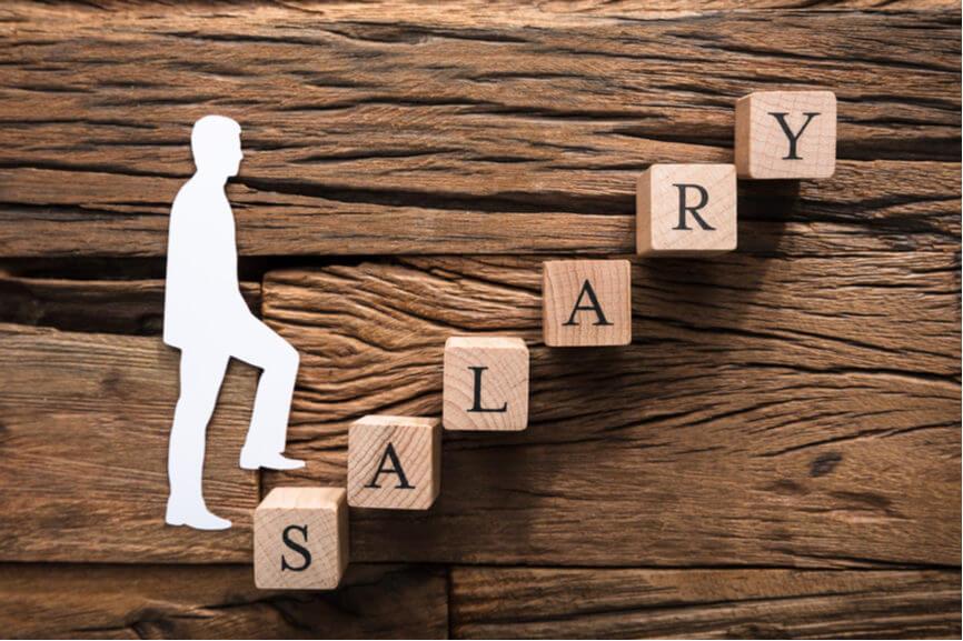 white silhouette walks up blocks that spell out the word salary