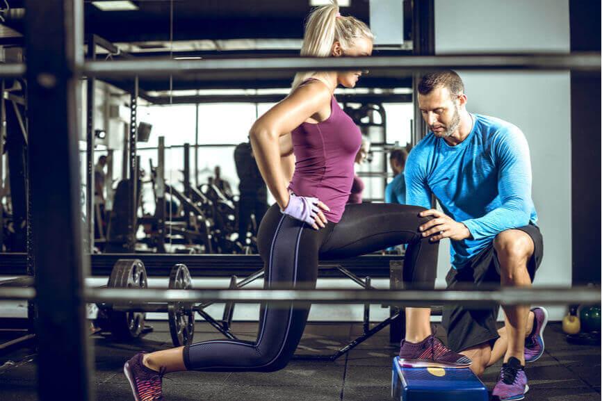 male personal trainer training woman