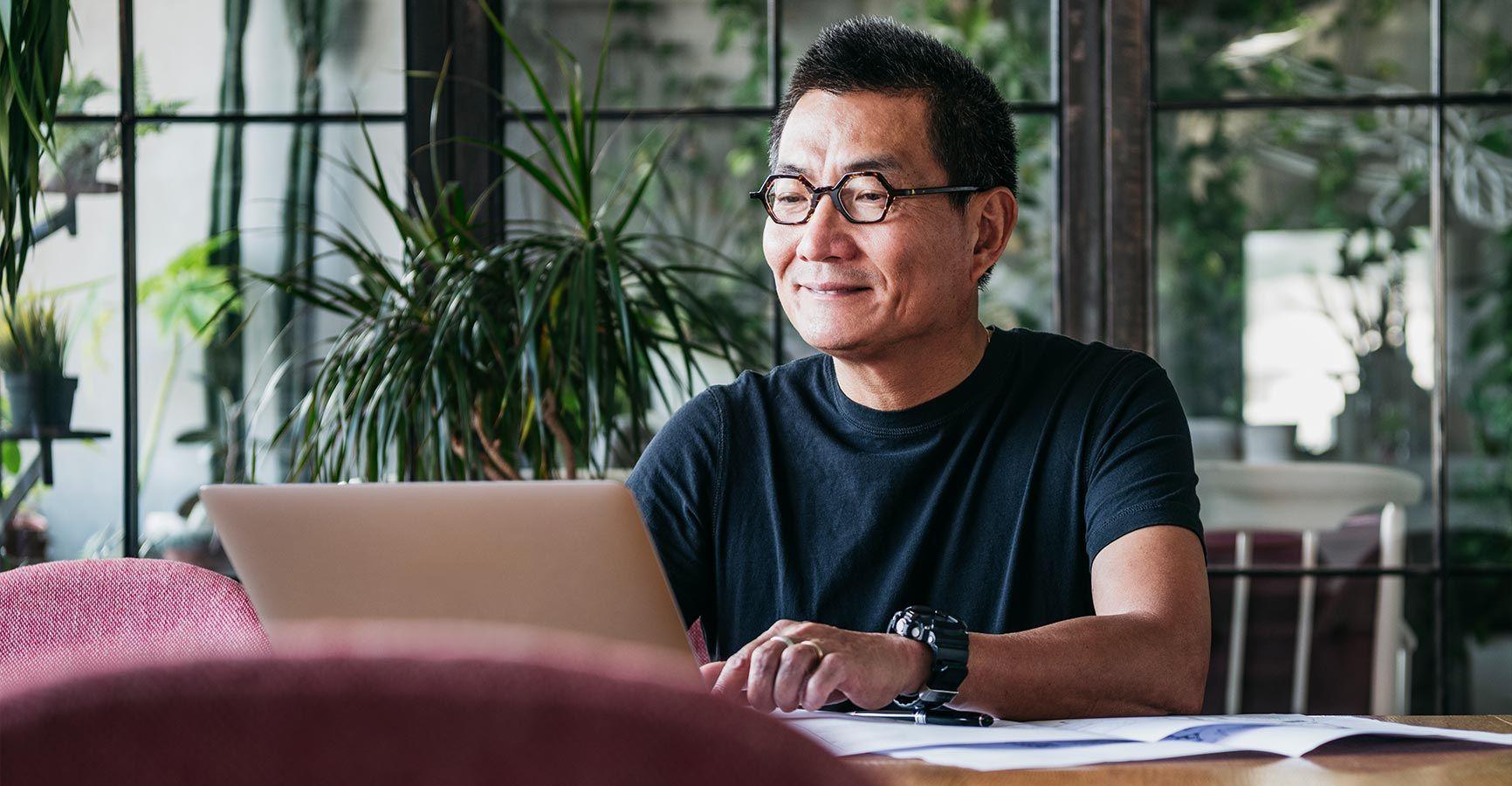 Stylish older man working on a laptop