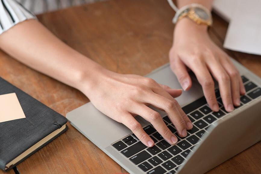 Woman typing on laptop