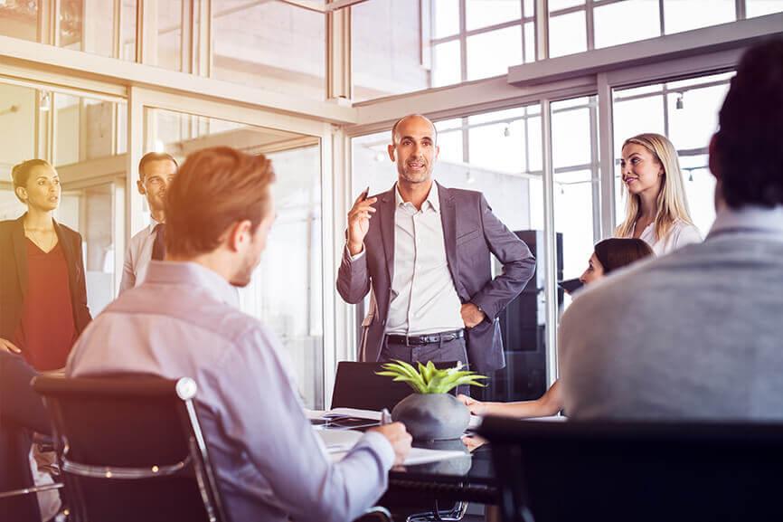 Man leading meeting with a group of coworkers