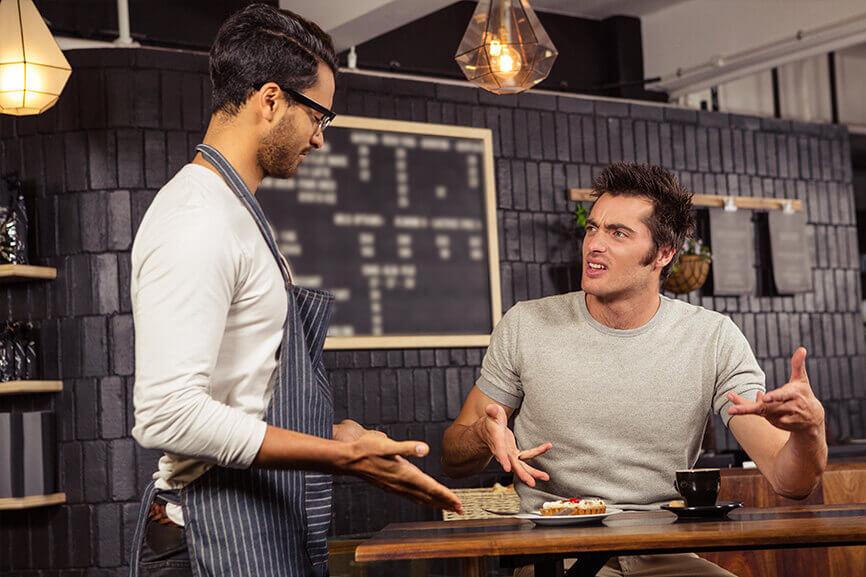 Waiter trying to help angry customer