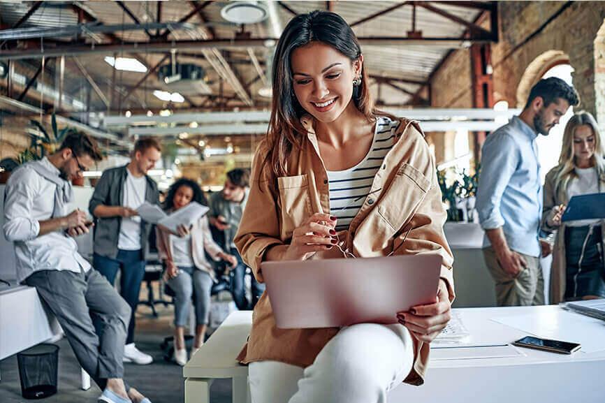 Woman looking at her laptop casually in the office