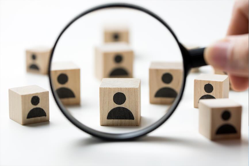 Image of magnifier and wooden blocks with people icon