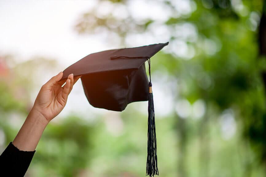 Person holding graduation cap