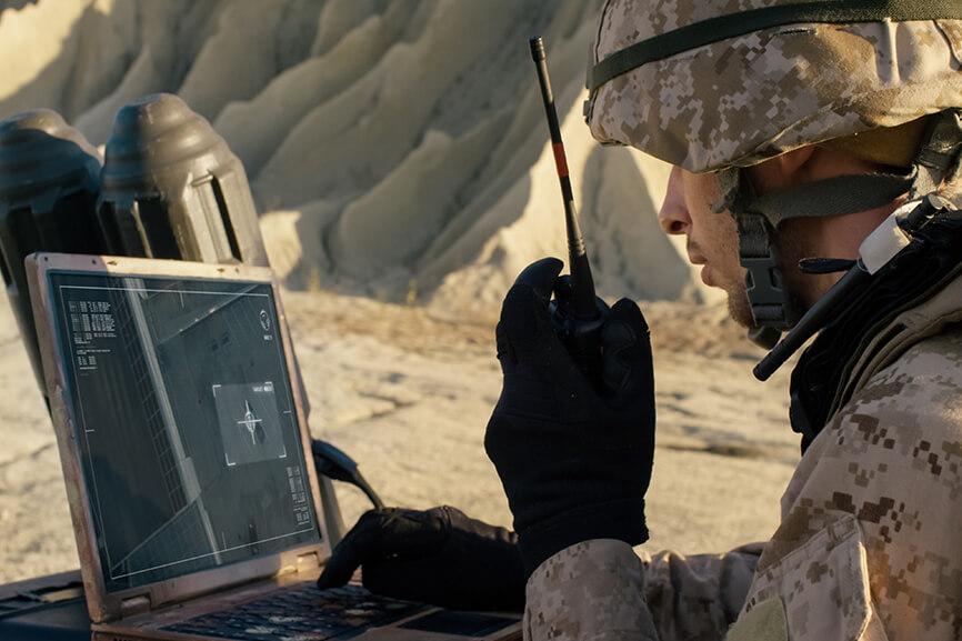 Military personnel talking on radio