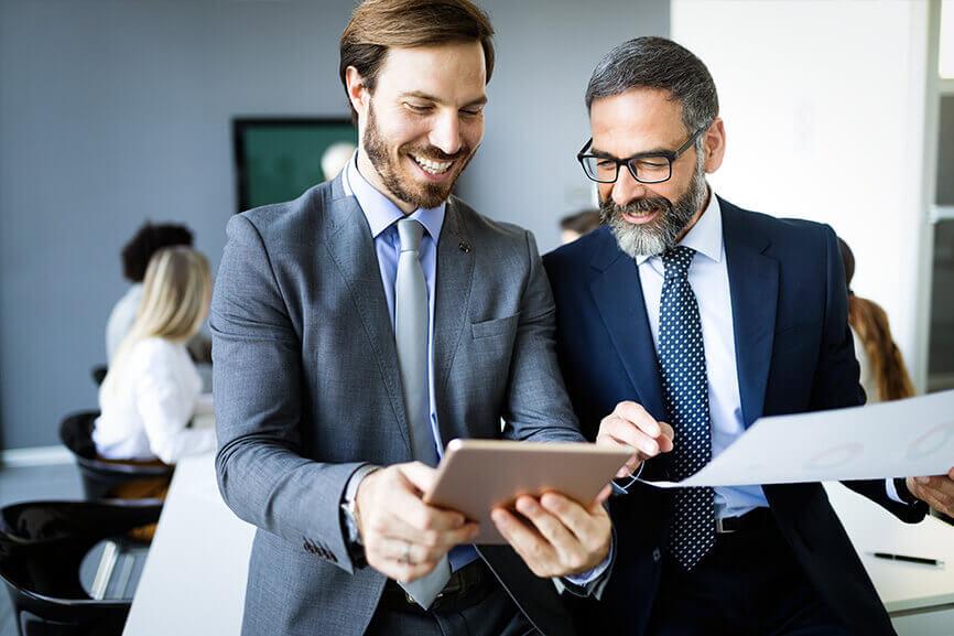 Two men looking at tablet