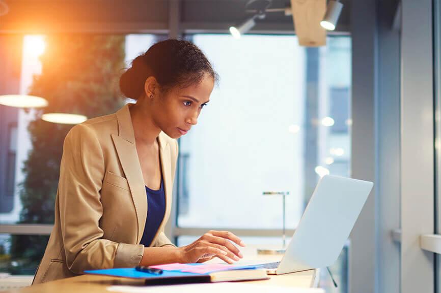 Woman typing and working on her laptop