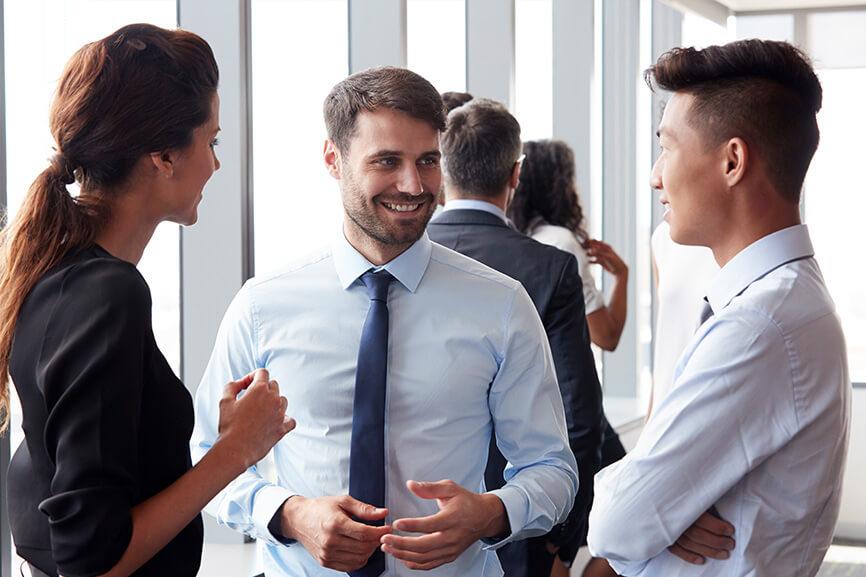 Three people in a conversation at work