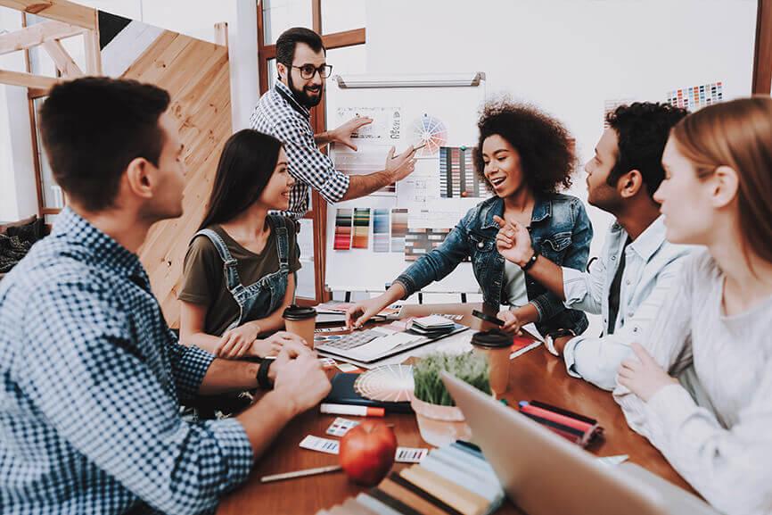 A group of people in a meeting room collaborating together