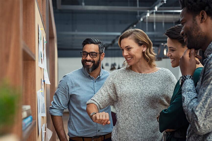 Woman and coworkers looking at project plans