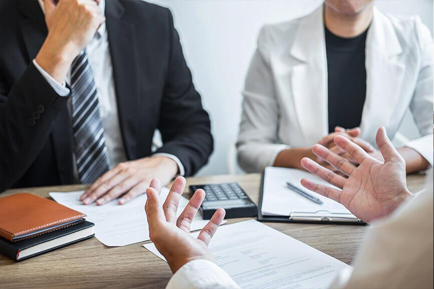 Two people interviewing one person