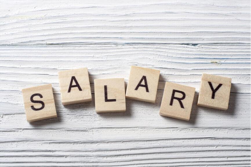 The word SALARY spelled out with Scrabble tiles