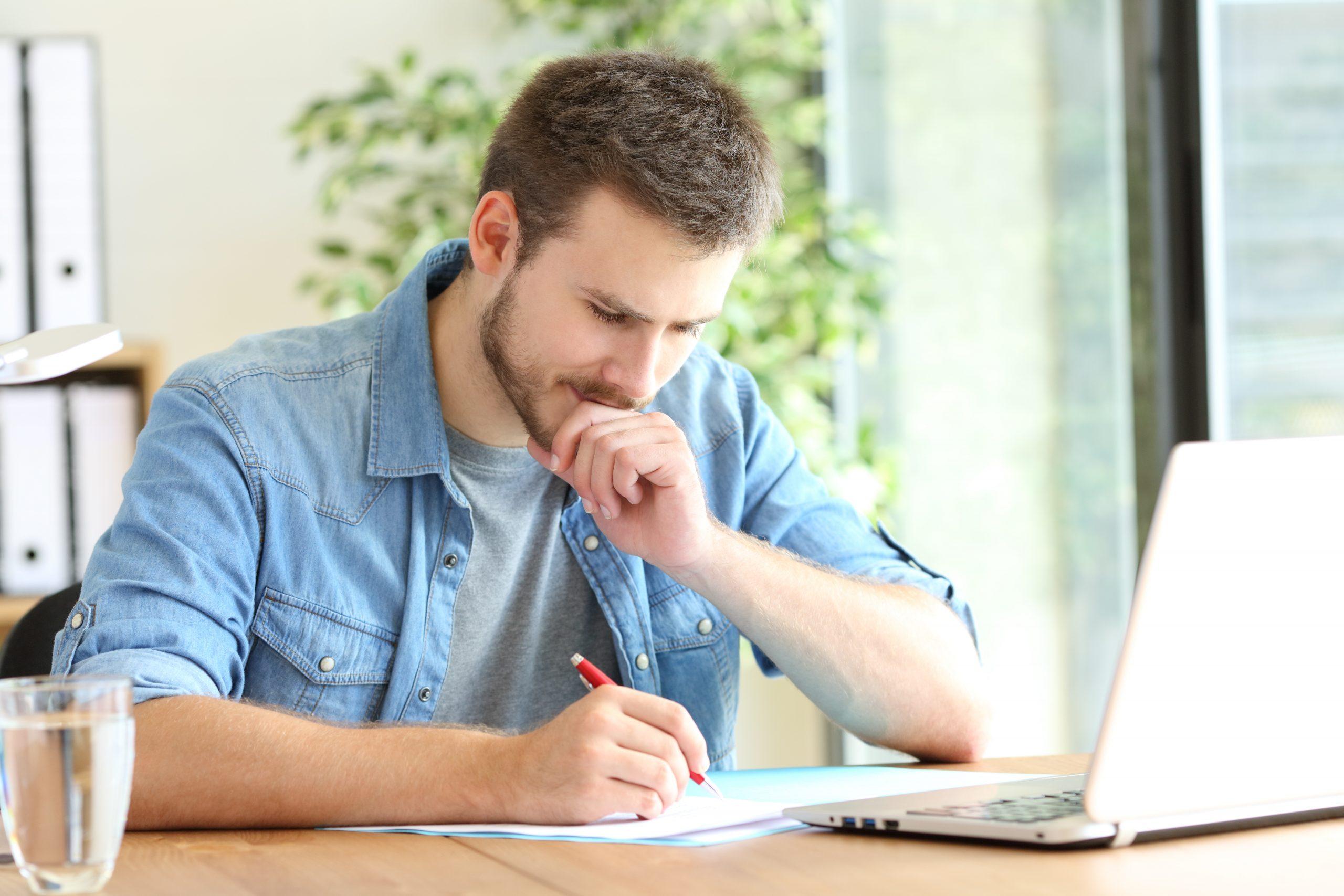 Pensive Man Writing A Letter Of Interest