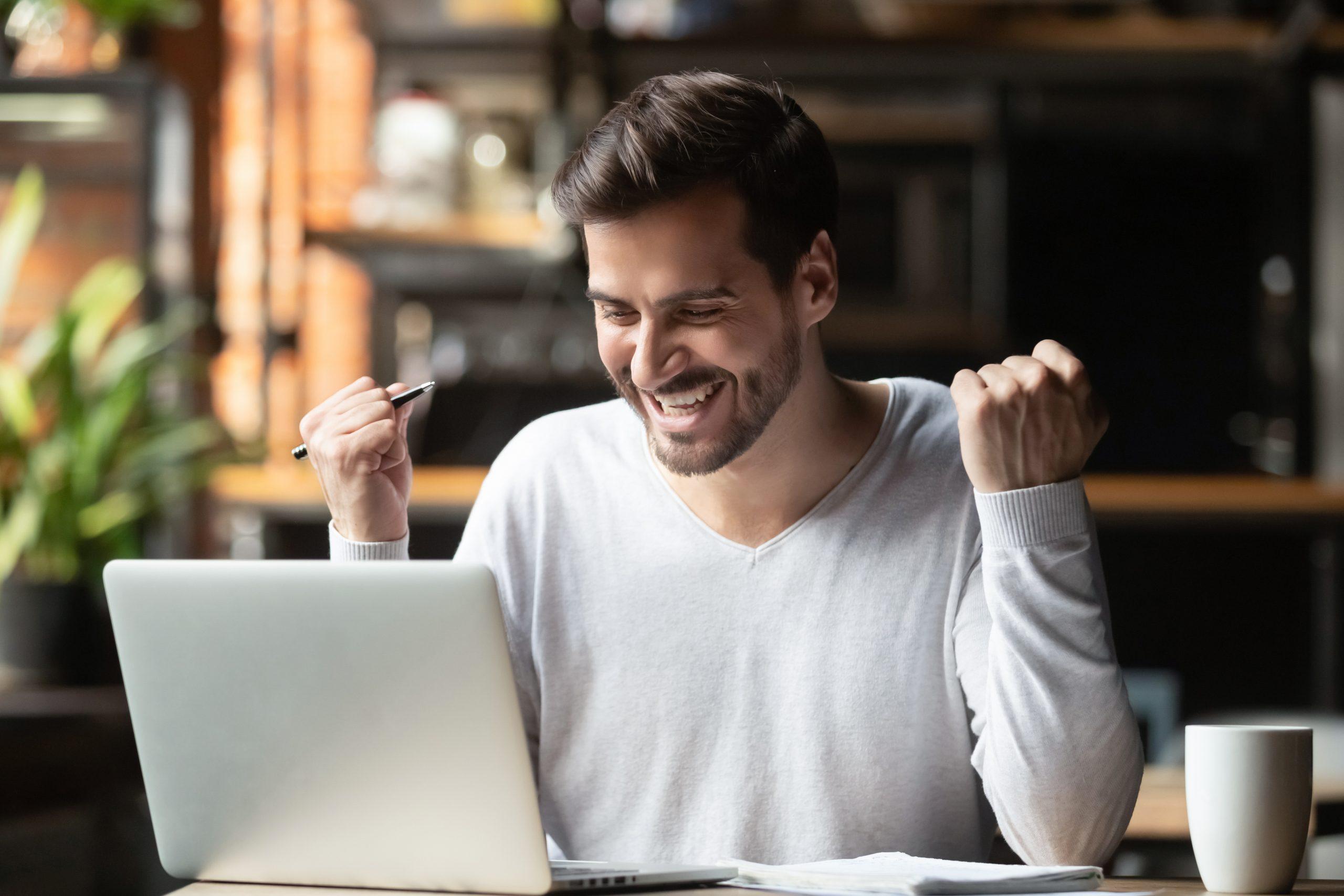 Young Man Excited While Using The Computer 1\